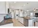 Kitchen featuring granite counters, stainless steel appliances, an island, and white cabinetry at 10432 High Noon Trl, Parrish, FL 34219