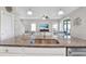 Modern kitchen featuring granite countertops, stainless steel appliances and an island with seating at 10432 High Noon Trl, Parrish, FL 34219