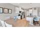 Kitchen featuring granite counters, stainless steel appliances, an island, and white cabinetry at 10432 High Noon Trl, Parrish, FL 34219