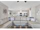 Spacious living room open to the kitchen and dining area with comfortable seating at 10432 High Noon Trl, Parrish, FL 34219