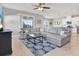 Spacious living room with a large sectional, ceiling fan, tile floors and backyard view at 10432 High Noon Trl, Parrish, FL 34219