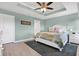 Inviting main bedroom featuring a tray ceiling and ample closet space at 10432 High Noon Trl, Parrish, FL 34219