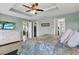 Bright main bedroom with tray ceiling with walk-in closet and bathroom at 10432 High Noon Trl, Parrish, FL 34219