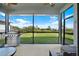 Enjoy this screened patio complete with a grill and an outdoor seating area overlooking the backyard at 10432 High Noon Trl, Parrish, FL 34219