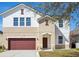 Charming two-story home with a two-car garage and manicured lawn, presenting an inviting facade at 11549 Tangle Branch Ln, Gibsonton, FL 33534