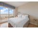 Bright bedroom featuring white bedding and a sliding glass door leading to a balcony at 1200 Gulf Blvd # 906, Clearwater Beach, FL 33767