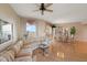 Bright living room featuring a striped sofa, wood floors, and a view of the water at 1200 Gulf Blvd # 906, Clearwater Beach, FL 33767