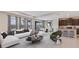 Open living area with large windows, a water view, a modern kitchen, and a connected dining area at 12059 Kingsley Trl, Parrish, FL 34219
