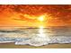 Beach sunset with bright orange clouds reflecting on the water at 1504 Valley Forge Blvd, Sun City Center, FL 33573