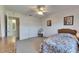 Cozy bedroom with carpet, floral bedspread, and access to an adjacent bathroom at 1504 Valley Forge Blvd, Sun City Center, FL 33573