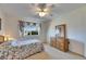 Inviting bedroom with a floral bedspread, carpet, and bright natural light at 1504 Valley Forge Blvd, Sun City Center, FL 33573