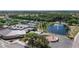 A beautiful clubhouse with a large parking lot, a pond with a fountain, and tennis courts in the background at 1504 Valley Forge Blvd, Sun City Center, FL 33573