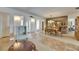 Open-concept dining room featuring a wood table with patterned chairs and adjacent entry way at 1504 Valley Forge Blvd, Sun City Center, FL 33573