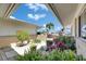 Beautiful courtyard entrance with lush tropical landscaping at 1504 Valley Forge Blvd, Sun City Center, FL 33573