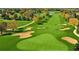 Aerial view of a lush green golf course with sand traps and mature trees at 1504 Valley Forge Blvd, Sun City Center, FL 33573