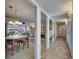 Hallway that connects the dining and living areas, showcasing open layout and ample natural light at 1504 Valley Forge Blvd, Sun City Center, FL 33573