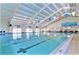 Indoor pool with plentiful light, decorated with festive colorful pennants and a mural at 1504 Valley Forge Blvd, Sun City Center, FL 33573