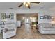 Cozy living room with a tile floor, comfortable seating, and plenty of natural light at 1504 Valley Forge Blvd, Sun City Center, FL 33573