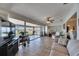 Bright living room with tile flooring, ceiling fan, comfortable seating, and a view of the water at 1504 Valley Forge Blvd, Sun City Center, FL 33573