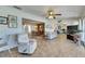Open-concept living room featuring tile flooring, comfortable seating, and views into the dining room at 1504 Valley Forge Blvd, Sun City Center, FL 33573