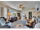 Comfortable living room with built-in shelving, natural light, and seamless access to other areas at 1504 Valley Forge Blvd, Sun City Center, FL 33573