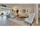 Inviting living room with plush floral seating and serene views of the water from the sliding glass door at 1504 Valley Forge Blvd, Sun City Center, FL 33573