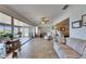 Spacious living room featuring tile floors, a ceiling fan, comfortable seating, and sliding doors at 1504 Valley Forge Blvd, Sun City Center, FL 33573
