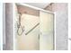 Walk-in shower with clear glass doors and a shower head with an assistive grab bar at 1504 Valley Forge Blvd, Sun City Center, FL 33573