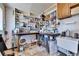 The storage room has tile flooring, open shelving, a large work desk, and a sink at 1504 Valley Forge Blvd, Sun City Center, FL 33573
