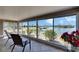 Screened sunroom boasting views of the scenic waterfront and beautiful landscaping at 1504 Valley Forge Blvd, Sun City Center, FL 33573