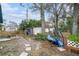 Spacious backyard featuring mature trees, storage sheds, and a swing, perfect for outdoor relaxation and activities at 1720 34Th N Ave, St Petersburg, FL 33713