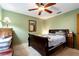 Comfortable bedroom with green walls, carpet, ceiling fan and wooden furniture at 1720 34Th N Ave, St Petersburg, FL 33713