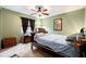 Comfortable bedroom with green walls, carpet, ceiling fan and large window at 1720 34Th N Ave, St Petersburg, FL 33713