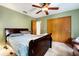 Bedroom featuring green walls, carpet, ceiling fan and closet at 1720 34Th N Ave, St Petersburg, FL 33713