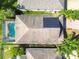 Aerial view of a house showcasing the backyard pool and solar panels at 19724 Fort King Run, Brooksville, FL 34601
