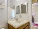 Bathroom vanity area with double mirrors, a sink, and a door to the shower at 19724 Fort King Run, Brooksville, FL 34601