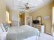Primary bedroom with coffered ceilings, neutral paint, and ample natural light from the windows at 19724 Fort King Run, Brooksville, FL 34601