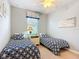 Bedroom featuring two twin beds, a window, and a ceiling fan at 19724 Fort King Run, Brooksville, FL 34601