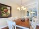 Elegant dining room with hardwood floors and stylish chandelier at 19724 Fort King Run, Brooksville, FL 34601
