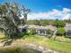Screened in pool area of a beautiful single-story home with mature landscaping and waterfront view at 19724 Fort King Run, Brooksville, FL 34601