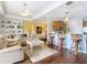 Open-concept living space features hardwood floors, built-in shelving and seamless flow to the kitchen at 19724 Fort King Run, Brooksville, FL 34601