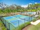 Enjoy outdoor activity on the community's pristine pickleball courts, surrounded by lush landscaping at 19724 Fort King Run, Brooksville, FL 34601