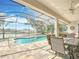 Spacious pool area offering serene lake views and comfortable outdoor seating at 19724 Fort King Run, Brooksville, FL 34601