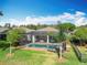 Backyard view of a screened pool with lush greenery and a privacy fence at 19724 Fort King Run, Brooksville, FL 34601