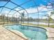 Screened-in pool offering a picturesque view of the serene lake at 19724 Fort King Run, Brooksville, FL 34601