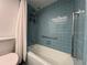 Bathroom displays light-blue tiled shower and walls, with updated shower hardware at 2630 Pearce Dr # 107, Clearwater, FL 33764