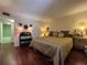 Bedroom with wood floors offers easy access to an en-suite bathroom at 2630 Pearce Dr # 107, Clearwater, FL 33764