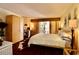 Bedroom with closet, desk, and balcony access features natural light, dark floors, and decorative mirrors at 2630 Pearce Dr # 107, Clearwater, FL 33764