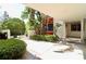 Inviting courtyard entrance with lush tropical landscaping, plants, and a secure gated entryway at 2630 Pearce Dr # 107, Clearwater, FL 33764