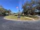 Community entrance with American flag flying at 2630 Pearce Dr # 107, Clearwater, FL 33764